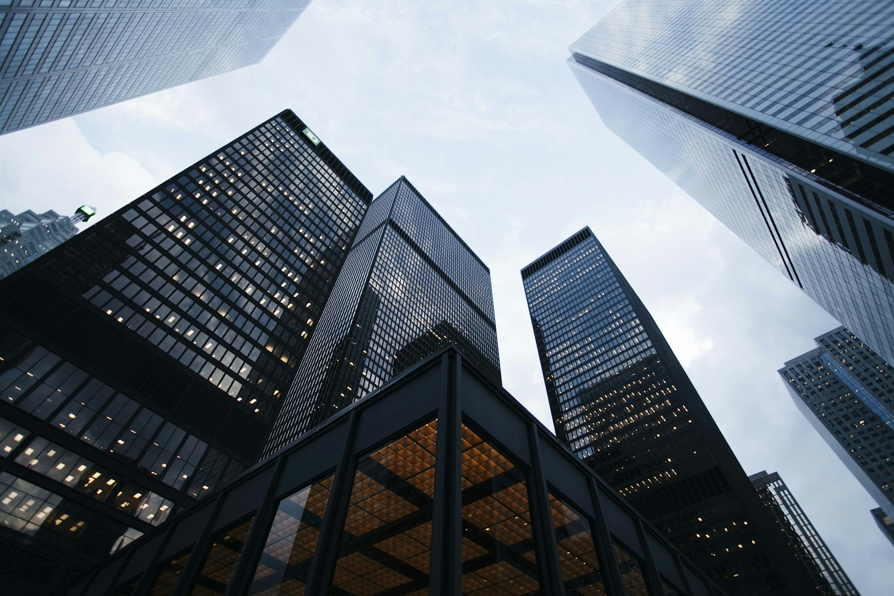 Modern glass office buildings viewed from ground level; illustrative architecture